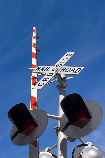 istock Railroad Crossing Sign and Raised Arm against Sky 90914651