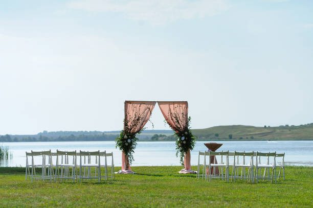 istock Wedding ceremony on the river bank 909146956