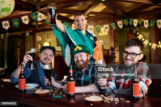 Happy Friends Enjoying Beer Party On St Patrick Day Stock Photo - Download Image Now