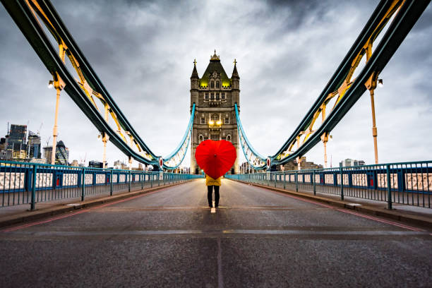 Girl with heart shaped umbrella on Tower Bridge, London stock photo