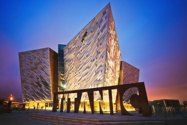 Sunset over Belfast Titanic, Belfast, Northern Ireland, UK Belfast, Northern Ireland - June 28, 2017: Sunset over Titanic Belfast - museum, touristic attraction and monument to Belfast's maritime heritage on the site of the former Harland and Wolff shipyard. belfast stock pictures, royalty-free photos & images