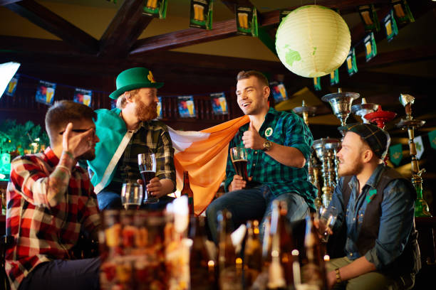 istock Happy friends chatting with beer in Irish pub 909149750