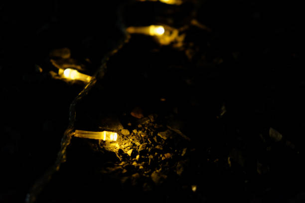 istock Glowing Christmas light on dark stone. Defocused 909154222