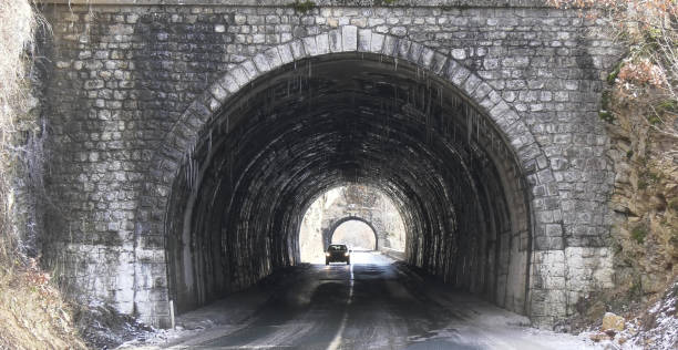 istock two Tunnels in winter with icicles 909157194