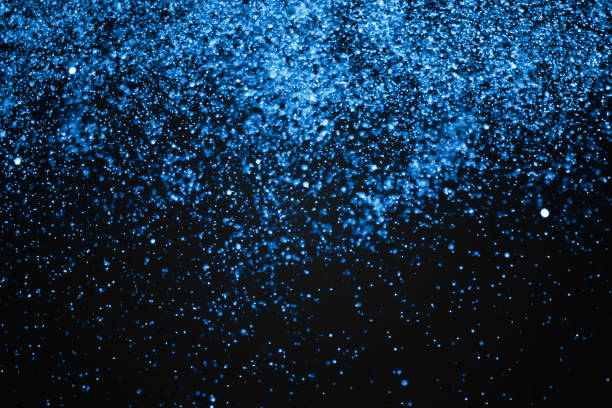 istock christmas blue gradient sparkle glitter explosion dust particles background with bokeh, color holiday happy new year and valentine day love, relationship 909158778