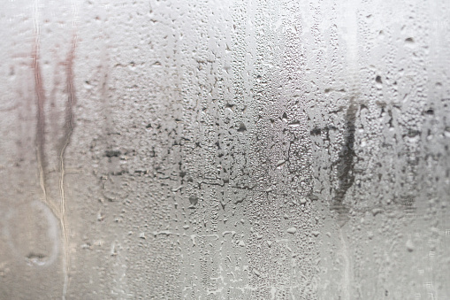 Condensation on window glass caused by high humidity in winter.