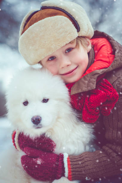 istock Boy enjoying winter with his dog 909163398