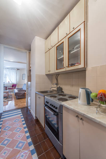 istock Little white kitchen in modern apartment interior 909164446