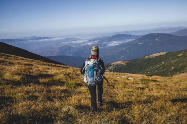 istock Hiker Girl Walk into the Mountains 909167286