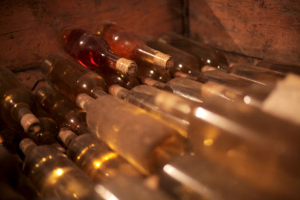 istock Old wine bottles stored in a cellar 909171540