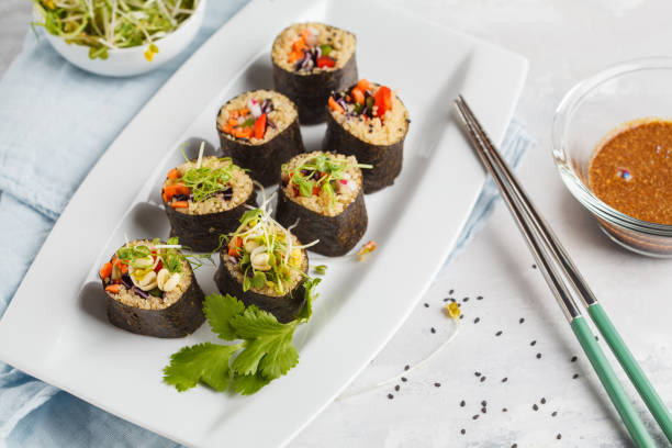 istock Vegan sushi rolls with quinoa, vegetables and soy-nut sauce on a white plate, light background. Vegan Healthy Food Concept. 909171864
