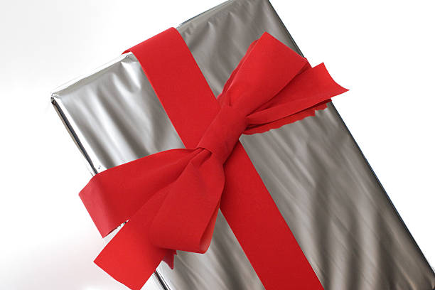Gift Wrapped in Silver with Red Bow on White stock photo