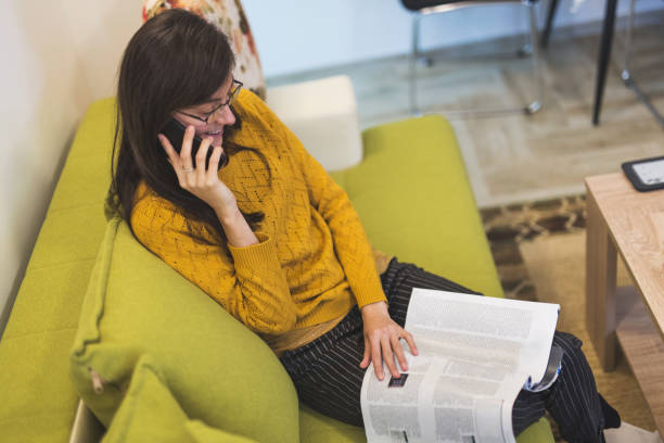 istock Young woman enjoys with magazine 909172816