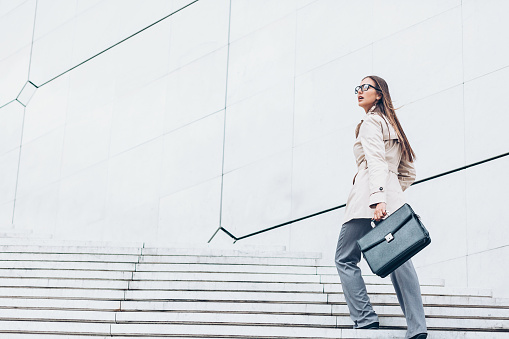 Businesswoman walking up on a staircase