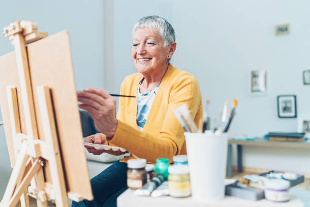 Devoting enough time to my favorite hobby Senior artist woman drawing at home drawing activity photos stock pictures, royalty-free photos & images