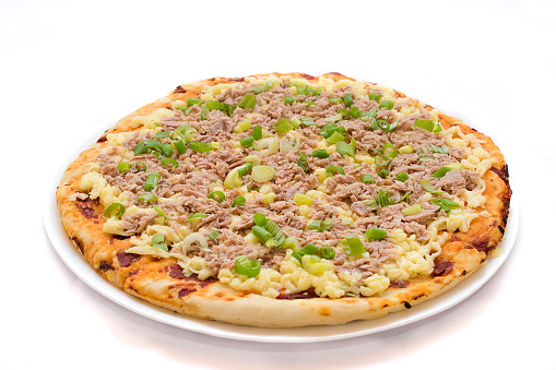 Raw pizza, with tuna and green onion. Isolated. White background.