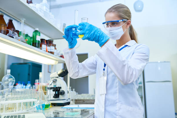 istock Female Scientist Holding Test Tubes 909176604