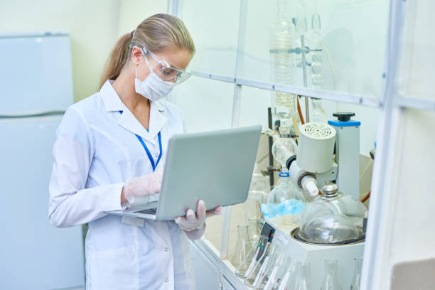 istock Female Scientist Using Laptop in Laboratory 909176642