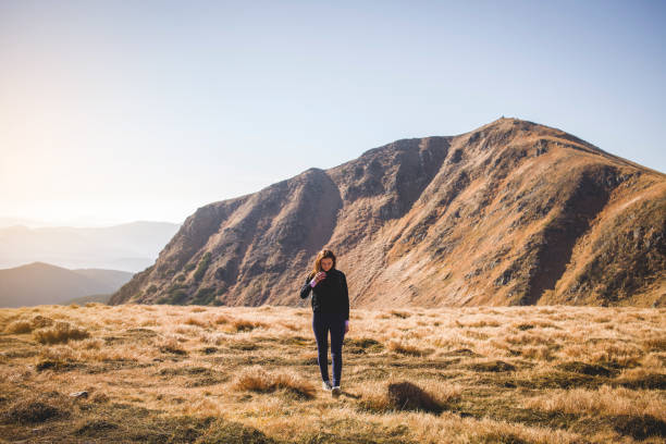 istock Lonely Girl Walking in Carpathian Mountains 909177160