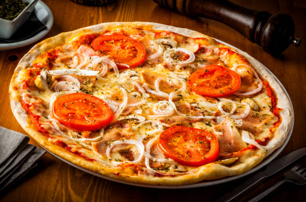 istock Hot pizza with mushrooms, bacon, tomato and onions 909181004