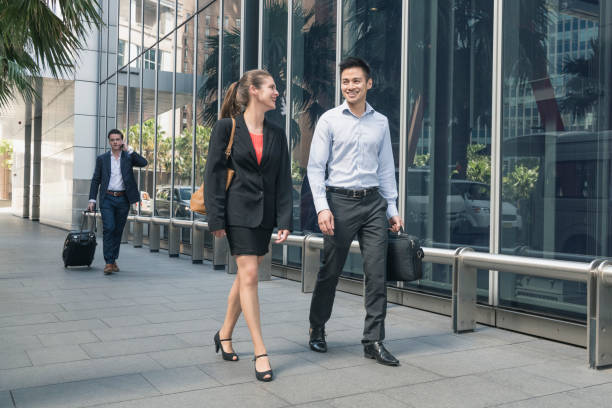 istock Business people walking past office building 909188030