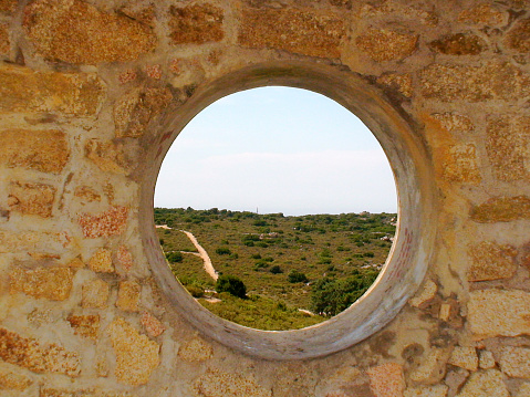 round stone window overlooking the Corsican countryside