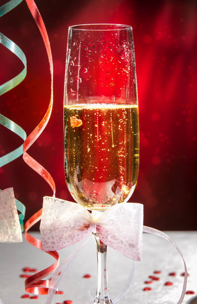 istock glasses of wine and serpentine on bright red background 909189082
