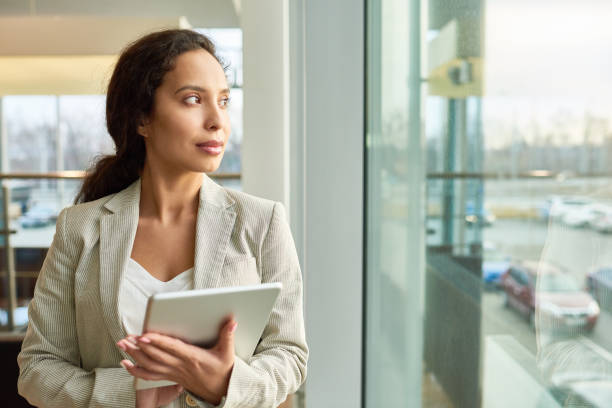 istock Mixed Race Businesswoman Looking out Window 909193452