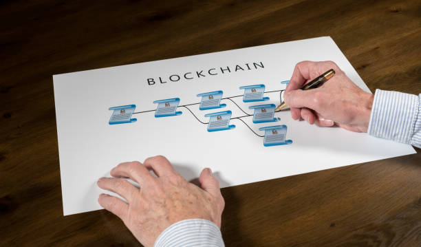 istock Senior technologist pointing to blockchain illustration 909196216