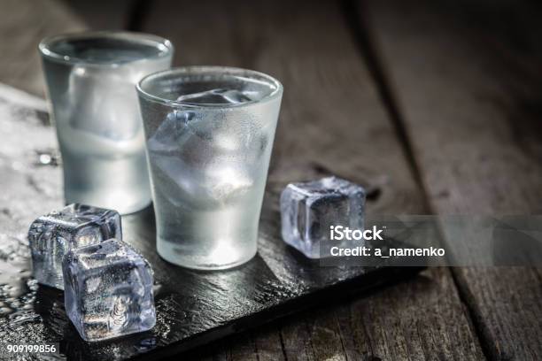 Vodka In Shot Glasses On Rustic Wood Background Stock Photo - Download Image Now - Vodka, Glass - Material, Alcohol - Drink