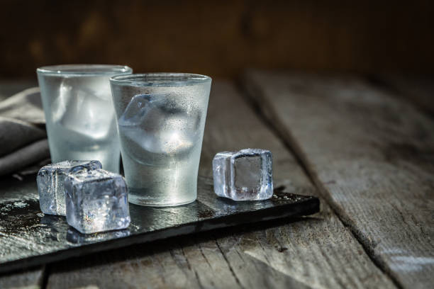 istock Vodka in shot glasses on rustic wood background 909199928