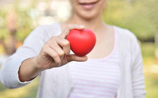 istock Asian Female is holding a Red heart. 909200990