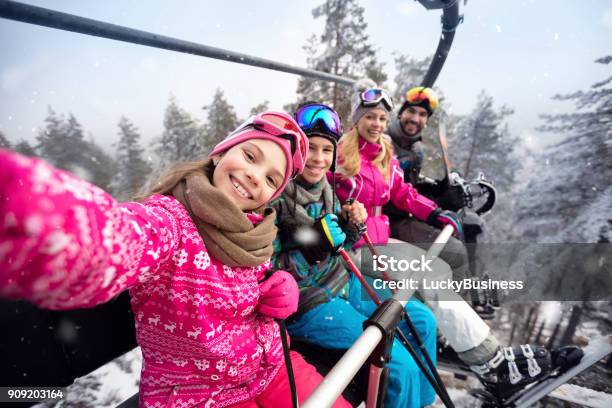 Happy Family In Cable Car Climb To Ski Terrain Stock Photo - Download Image Now - Family, Skiing, Ski