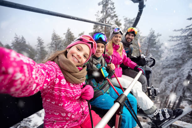 happy family in cable car climb to ski terrain - skii imagens e fotografias de stock