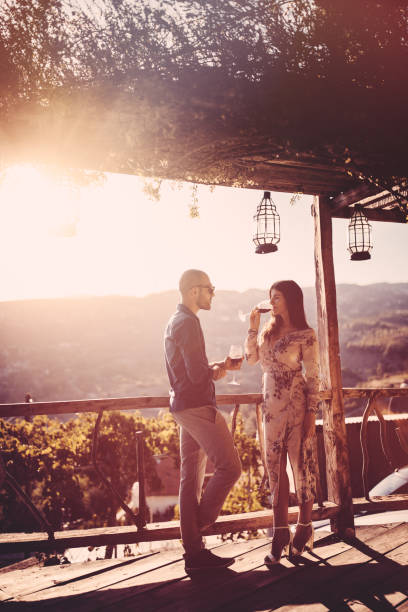 istock Young romantic couple drinking wine on rustic cottage village 909204010