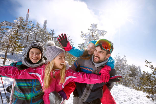 istock Cheerful family having fun on skiing 909204310