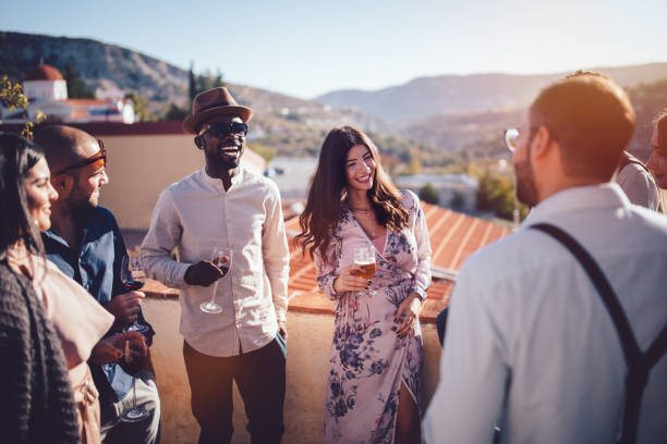 Young multi-ethnic friends drinking wine and beer in rustic village Young elegant multi-ethnic friends and couples relaxing at wine and beer tasting at French village nice france restaurant stock pictures, royalty-free photos & images
