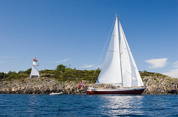 Sailboat and lighthouse stock photo