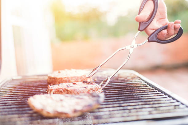 Man cooking the meat on the grill