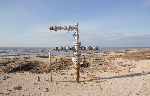 Natural gas wellhead on the sandy beach