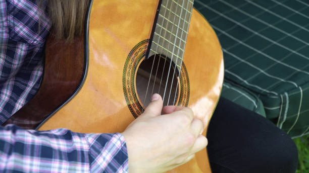 istock Girl playing the guitar 909225182