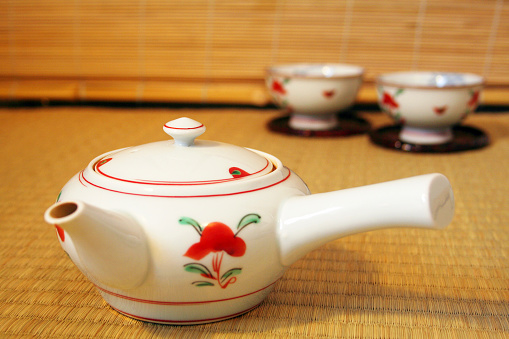 Closeup of Hot Chinese Oolong Teacups and Teapot