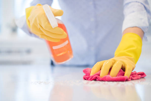 Close Up Of Woman Using Spray Polish To Clean Kitchen Surface Close Up Of Woman Using Spray Polish To Clean Kitchen Surface surface disinfection stock pictures, royalty-free photos & images