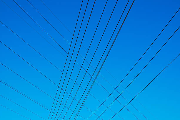 Crossing power lines stock photo