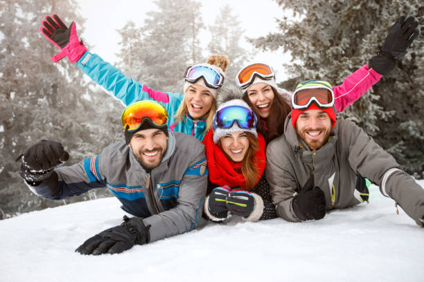 istock Friends on skiing laying together on snow 909240508