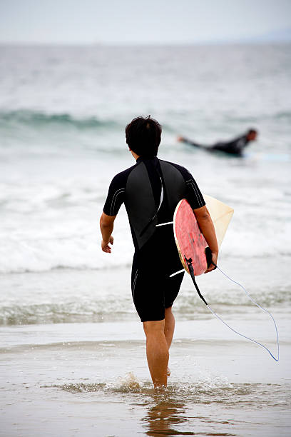 istock coastal California scene - surfer and board 90924299