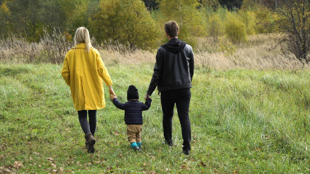 istock Young family on a walk in the park 909246192