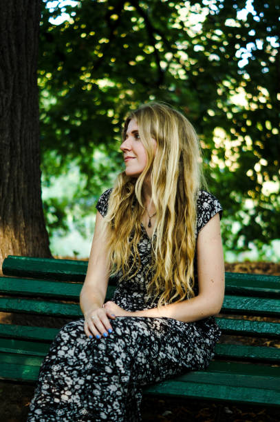 istock Beautiful sad blonde girl sitting alone 909246780