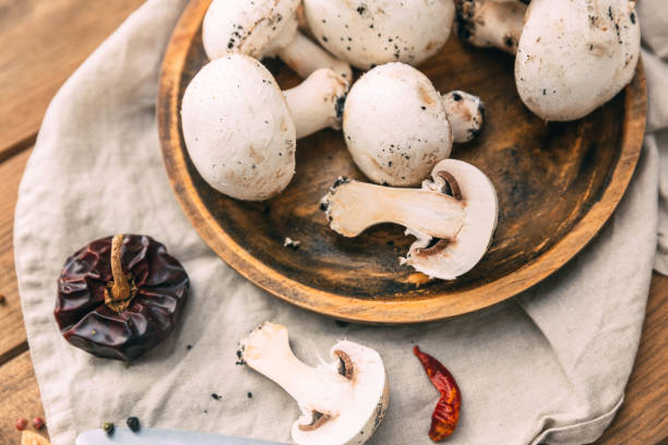 istock Mushrooms champignon on wooden background. Copy space. 909251068