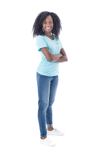 Mid adult African American female volunteer stands confidently with her arms crossed while looking at the camera.